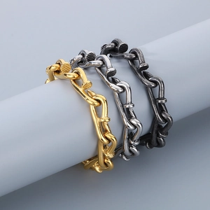 Close-up of interlocking nail bracelets in gold, silver, and vintage black finishes