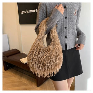 Chic khaki faux fur handbag with fringe detail styled with a grey cardigan