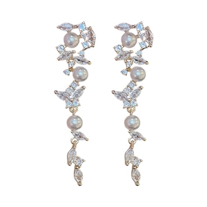French style gold vine earrings with marquise zircons and white faux pearls on white background