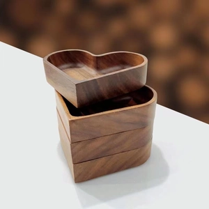 Stackable heart-shaped solid wood trays set in walnut finish with natural grain pattern