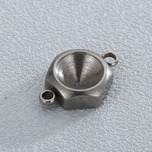 Macro shot of silver stainless steel hexagonal birthstone setting with dual hanging loops