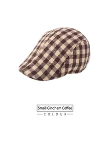 Detailed view of the coffee brown plaid pattern texture on the British style flat cap