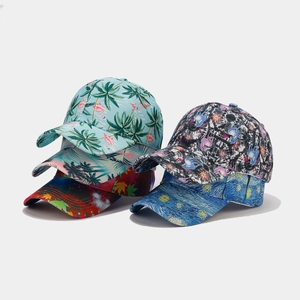 Detail shot of printed baseball caps with tropical flamingo, maple leaf, and starry art patterns