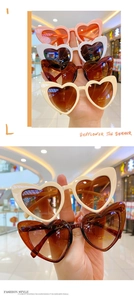 Close-up of heart-shaped UV400 sunglasses in various colors with CE certification mark