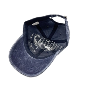 Detail of the washed cotton baseball cap interior featuring a black sweatband and metal buckle