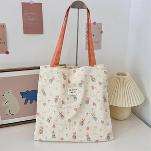 Close-up of cute rabbit prints and orange handle on a double-layer canvas tote bag