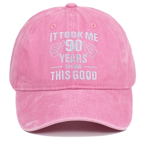 Detail of pink washed cotton baseball cap with 90 years birthday embroidery