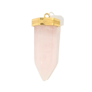 Macro detail of hexagonal pink crystal pendant with sunburst relief on golden cap
