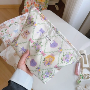 Close-up of floral cotton pouch with bear prints and simple wish woven label