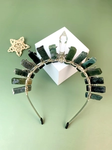 Detail of green crystal crown headband with silver wire wrapping and central white quartz