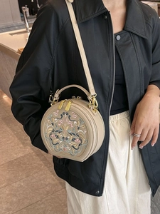 Round ethnic embroidered shoulder bag in beige with floral patterns and top handle