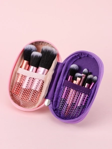 Detail of pink and purple travel makeup brush cases with mesh pockets and zip closure