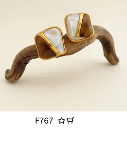 Macro detail of geometric vintage ring with gold trim and amber marble resin inlays