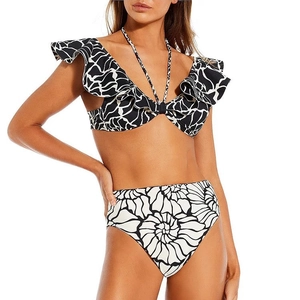Close-up of ruffled bikini top with polka dot print and high-waisted floral bottoms