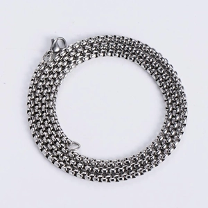 Close-up of a silver stainless steel box chain necklace with a lobster clasp on white background
