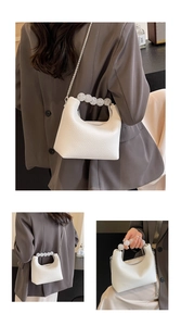 Three-way view of white textured dumpling bag with pearl handle and silver chain