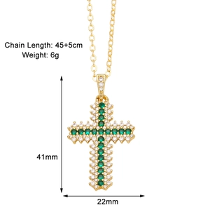 Detail view of gold cross necklace with green zircon inlay and size dimensions