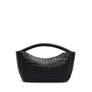 Detail of hand-woven black leather texture on a stylish mini hobo handbag