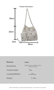 Detailed view of white quilted polyester tote bag with bow embroidery and size dimensions
