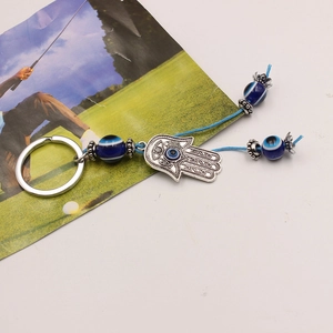 Ethnic style Hamsa Hand keychain with blue Evil Eye beads and a braided lanyard