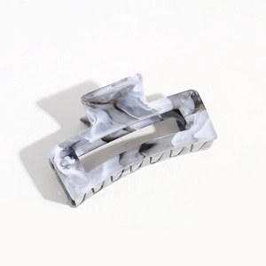 Detail view of square hair claw clip featuring grey and white marble pattern texture