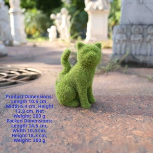 Detailed view of green flocked cat garden ornament on a stone path in outdoor setting