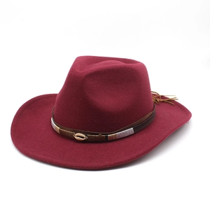 Close-up of wine red wool felt fedora with braided leather band and shell ornament