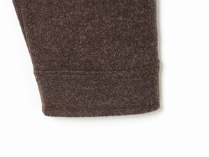 Detailed close-up of dark brown knitted sleeve cuffs with high-quality reinforced stitching