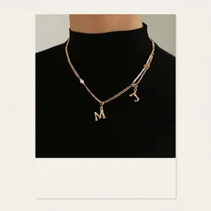 Minimalist gold-plated bamboo-style letter M and J necklace with pearl accents
