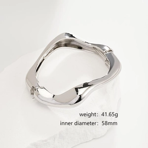 Detail view of silver irregular wave bracelet on white stone with weight and size specs