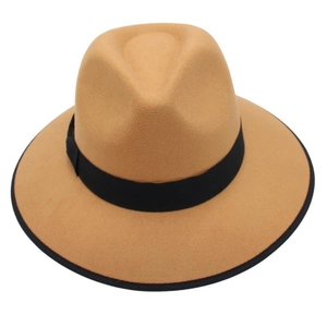 Close-up of a camel wool felt fedora featuring a black trim edge and a decorative hat band