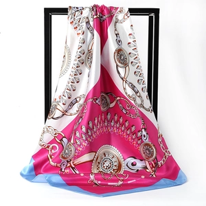 Silky satin square scarf featuring vintage chain and jewel prints with a draped hang