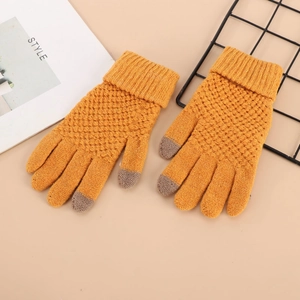 Detail of yellow knit winter gloves featuring gray touchscreen fingertips and soft texture