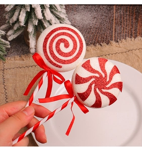 Detail of red and white glittery Christmas lollipop ornaments with ribbon bows