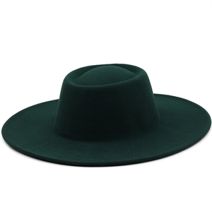 Detailed texture of dark green wool felt bolero hat with wide flat brim and oval top