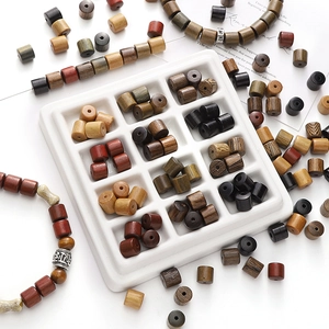 Macro shot of assorted natural sandalwood beads with engraved Buddhist mantra symbols