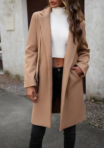 Street style view of a long camel wool coat with classic lapel and minimalist design