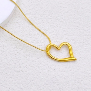 Golden hollow heart pendant necklace with sleek snake chain for men and women
