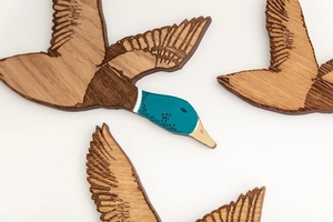 Artisanat détaillé de trois canards volants en bois avec têtes sarcelle et textures sculptées