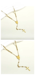 Detailed close-up of golden rosary cross necklace with religious medal on white background