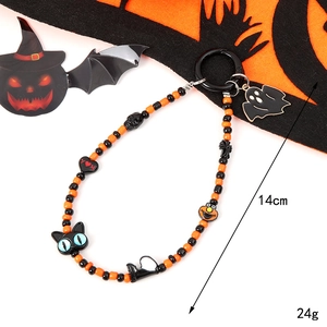 Halloween phone charm strap with black beads, orange charms, and Elmo figure