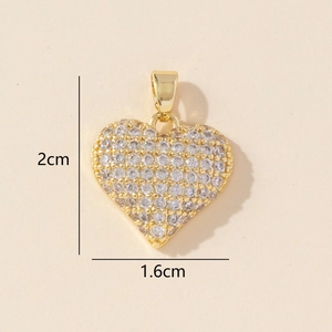 Macro view of gold heart pendant with cubic zirconia inlay and 2cm by 1.6cm dimensions