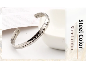 Detailed macro view of wheat chain patterned stainless steel bangle with C-shape opening