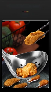 Macro shot of 304 stainless steel slotted spoon lifting fried food from hot oil