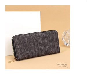 Macro detail of fashionable long striped lady's purse with golden zipper and vintage texture