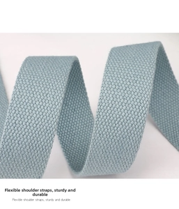 Detail of light blue nylon shoulder strap with diagonal weave texture and flexible design
