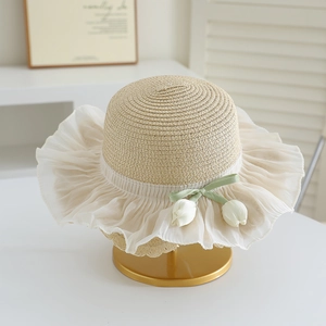 Detail of straw hat with tulip charms, lace ruffle brim and green ribbon bow decoration