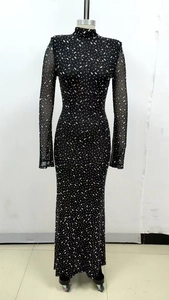 Detail of black mesh long sleeve maxi dress with shimmering silver rhinestones