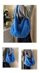 Detail of blue plush tote bag with long faux fur texture and wide shoulder strap
