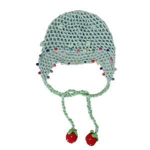 Green knit baby beanie with colorful beads and cute strawberry tassel pendants on white background